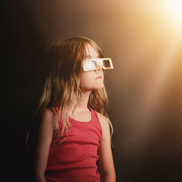 Child Looking Up at Solar Eclipse