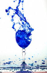 blue wine splash in the glass on white background,blue water drop splash on white background