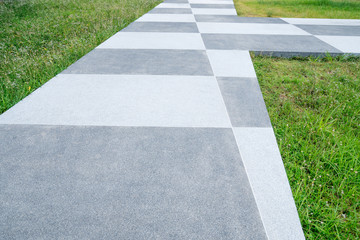 Chess concrete pathway and green grass