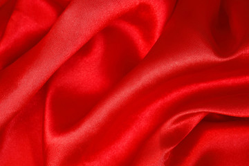 Fototapeta na wymiar The shiny red fabric background looks lush