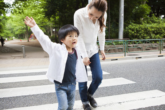 Mom and child crossing sidewalks