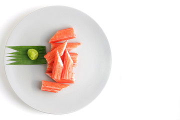 Imitation Crab Stick on a plate isolated on white background with clipping path, Japanese food