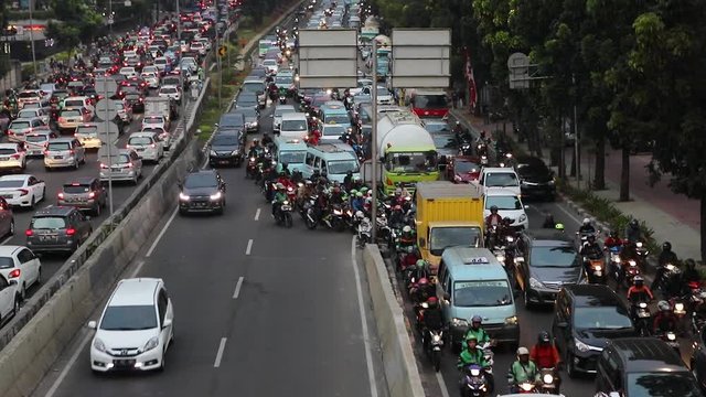 JAKARTA, Indonesia. August 14, 2017: Video footage of crowded cars and motorcycle on traffic jam in Casablanca street at Jakarta