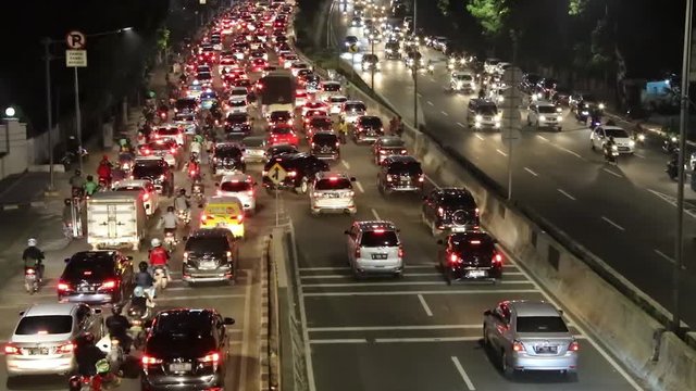JAKARTA, Indonesia. August 14, 2017: Video footage of rush hour traffic with crowded cars and motorcycle on Casablanca highway at night