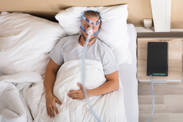 Man With Sleeping Apnea And CPAP Machine
