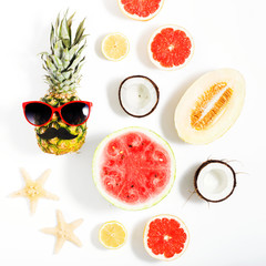 Creative layout made of pineapple with sunglasses and various fruits