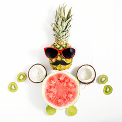 Creative layout made of pineapple with sunglasses and different fruits
