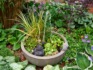 Small water fountain in a beautiful garden