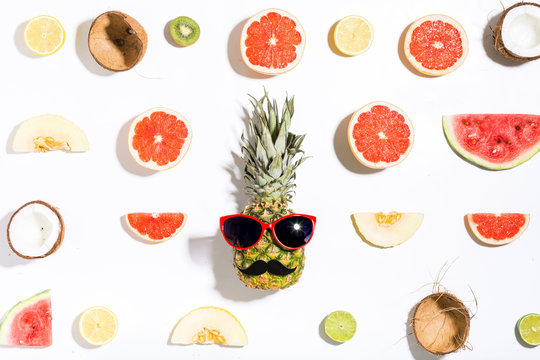 Creative layout made of pineapple with sunglasses and various fruits