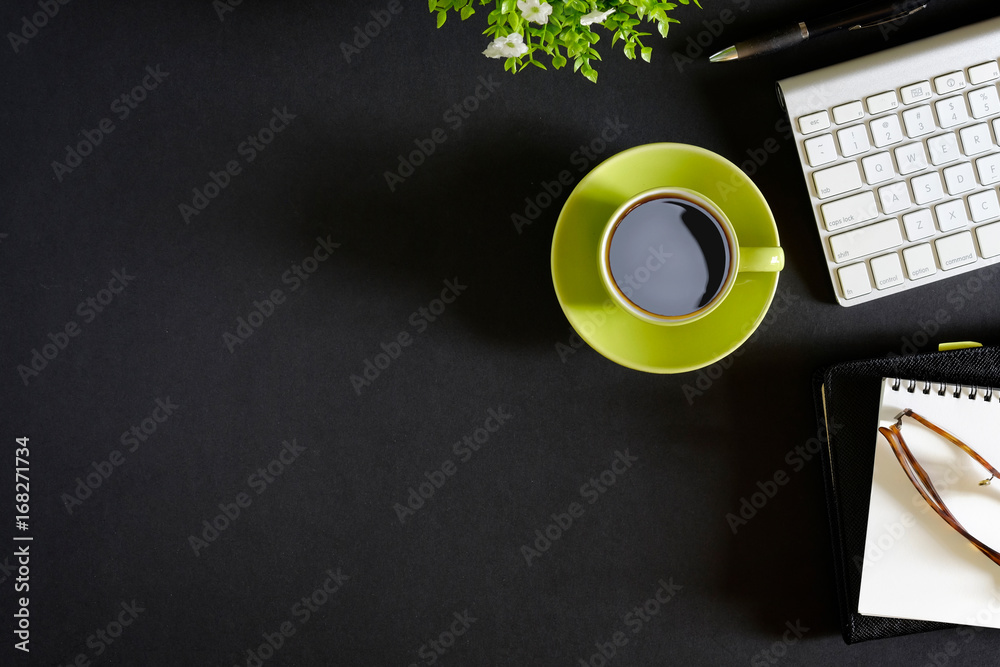 Wall mural office leather dark desk table with computer, supplies and coffee cup. top view with copy space