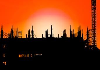 silhouette of construction on industry site at concept sunrise time with sun light effect background with copy space add text