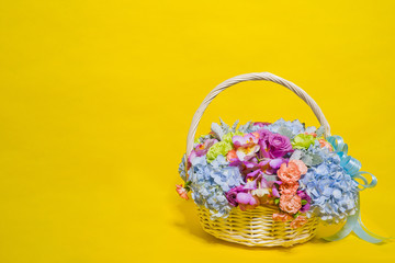 Fototapeta na wymiar flower basket on yellow background