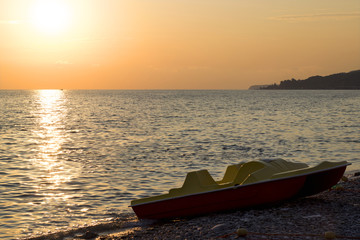 Sunset on the beach with a water bike