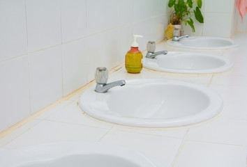 chrome faucet old on white sink in the bathroom with copy space add text