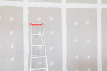 stair and gypsum board wall interior decoration of home at construction site with copy space add text