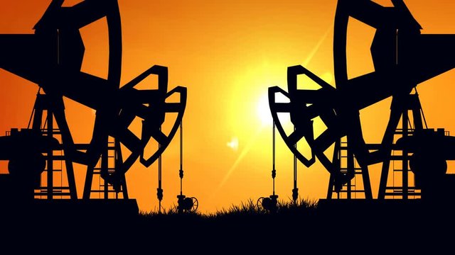 Silhouette pump jacks at sunset. Oil industry. 