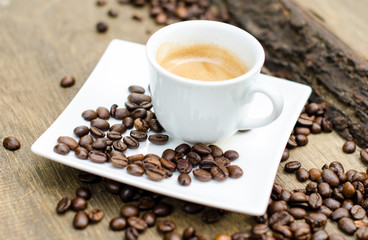 Good Morning: Close up white coffee cup  on wood tab / Cup of latte art coffee with coffee beans :) 
