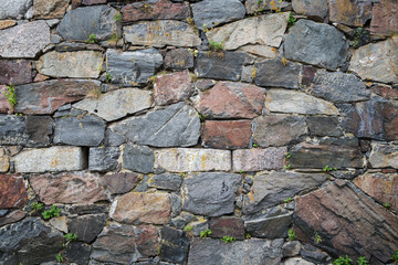 Close-up of an old surrounding wall at a fortress made of stones with vignetting.