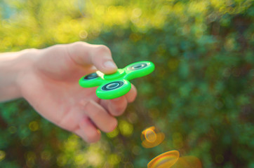 teenager hand holding antistress fidget spinner