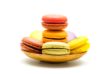 Colorful sweet macarons in wooden plate