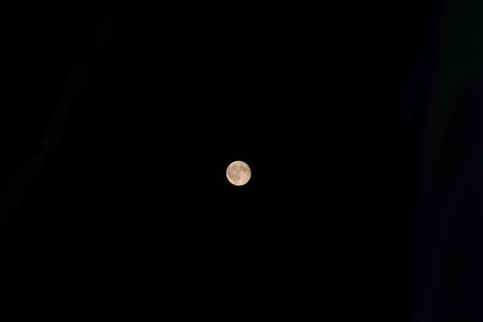 Full moon on dark black sky at night. Astronomy shot of the planets and the starry sky. The scene with the round moon. The mystical nature time