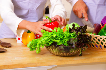 People is preparing for making salad with lots of vegetable