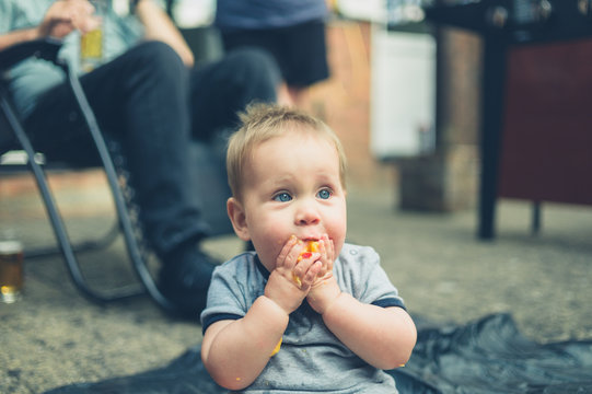 Little baby eating a peach outside