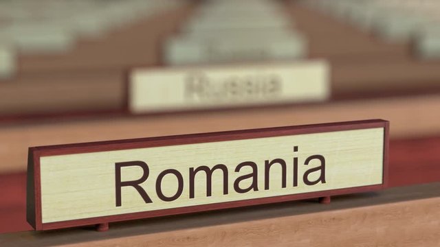 Romania name sign among different countries plaques at international organization. 3D rendering