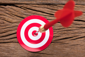 Red Arrow In Dartboard On Table