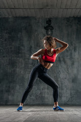 Fototapeta na wymiar Young beautiful dancer is posing in studio