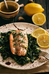Baked salmon served on stewed spinach with lemon butter sauce.