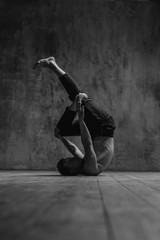 Young beautiful dancer is posing in studio