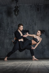 Fototapeta na wymiar Couple of ballet dancers posing in studio