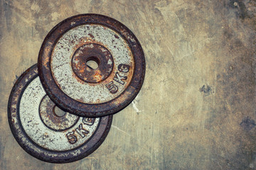 Two old rusty 5kg Weight Plates on floor