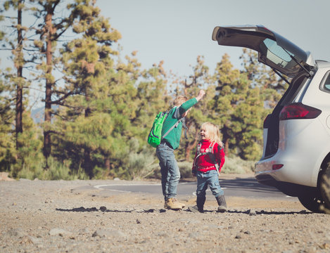 family car travel - happy little boy and girl get ready for hiking