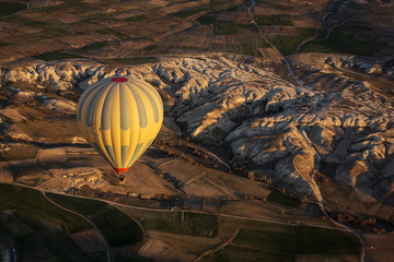Obraz premium Balloon over Valleys of Cappadocia in background, aerial view