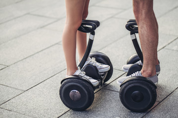 Fototapeta na wymiar Young couple on gyro scooters