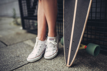 Female teenager with skateboard