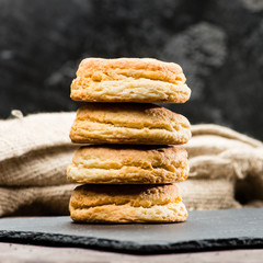selective focus on classical Italian fresh delicious homemade raisin scones on table, dark background