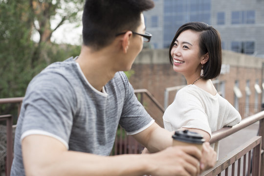 Cheerful young couple talking outdoors