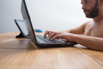 man working at home with laptop