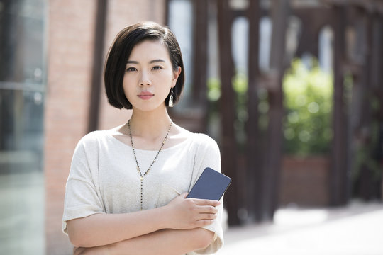 Beautiful young woman holding a smart phone