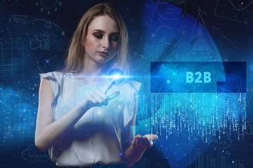 The concept of business, technology, the Internet and the network. A young entrepreneur working on a virtual screen of the future and sees the inscription: B2B