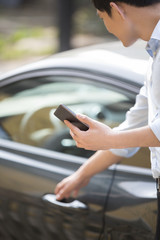 Young businessman opening car door