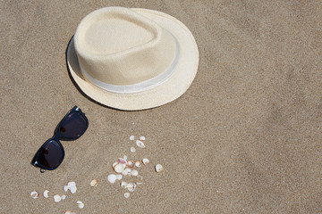 Fototapeta na wymiar Hat and sunglasses on the beach.