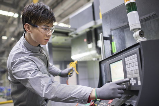 Confident engineer working in the factory