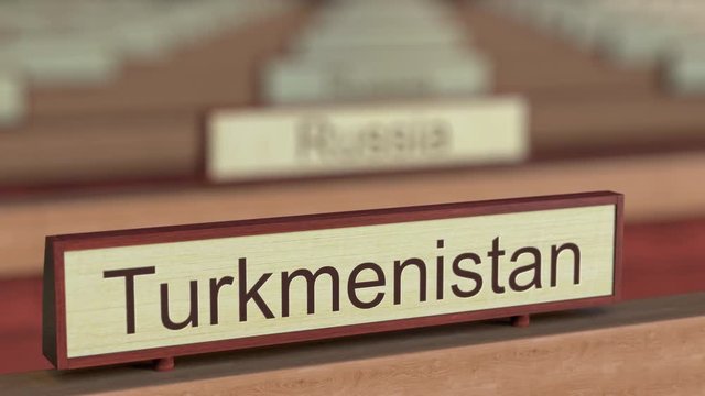 Turkmenistan name sign among different countries plaques at international organization. 3D rendering