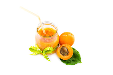 Glass jar with apricot jam isolated on white background.