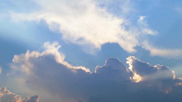 Beautiful timelapse with large clouds and sunshine breaking through cloud mass.