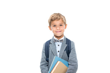 schoolboy with books and backpack